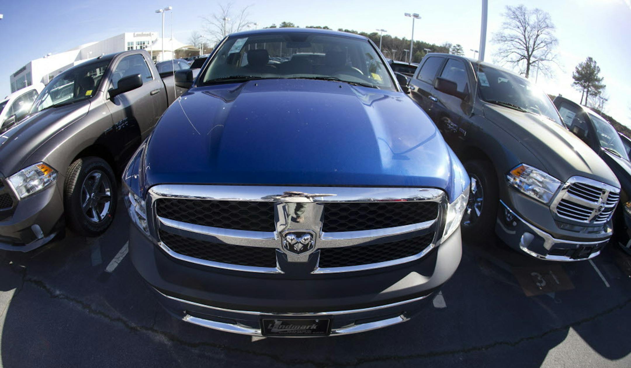 Dodge Ram pickup trucks are on display on the lot at Landmark Dodge Chrysler Jeep RAM Monday, Jan. 5, 2015, in Morrow, Ga. Buoyed by a resurgent economy, holiday sales, cheap gasoline and a love affair with pickup trucks, Americans headed to car dealers in droves last month, pushing full-year sales to what's likely to be the highest level since 2006. (AP Photo/John Bazemore)