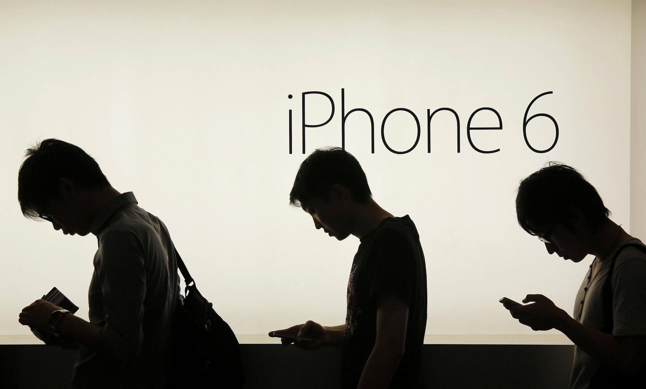 File-In this file photo from Friday, Sept. 19, 2014, people wait to buy the new Apple iPhone 6 and 6 Plus devices outside an Apple store in Hong Kong. Each year, Apple dazzles its devoted fans with faster, sleeker, more powerful iPhones with better cameras and a bevy of bells and whistles. So, what's to become of last year's model? Instead of sentencing it to a lonely existence in a desk drawer, there are plenty of ways to reuse, recycle or resell older phones. (AP Photo/Vincent Yu)