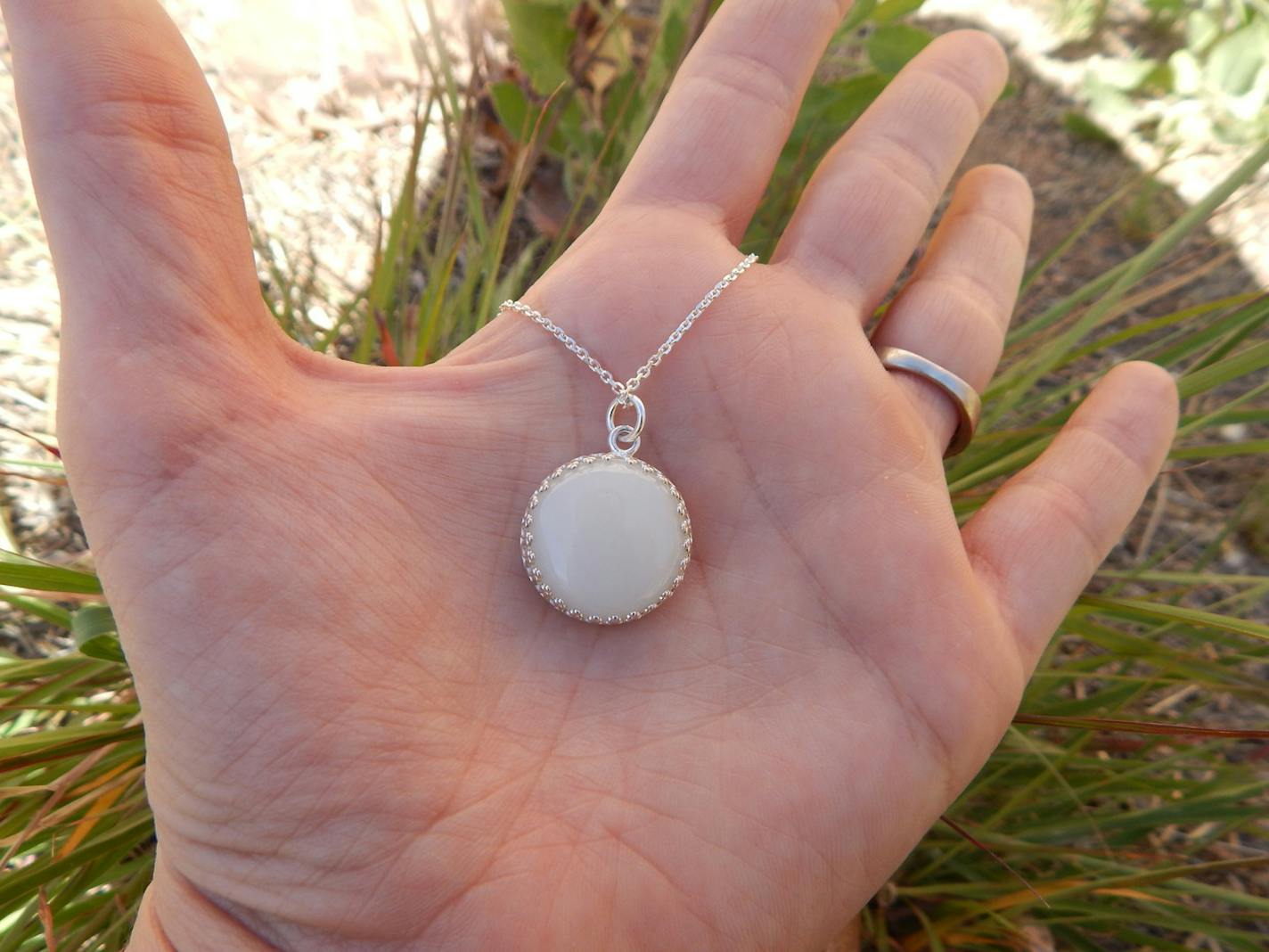 A silver pendant made of breast milk.