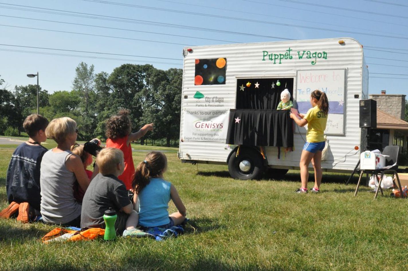 Photos by Liz Rolfsmeier
(left to right) Conner Delmonico, 9, and Carrie Delmonico of Eagan; Olive, 2, and Oscar Hansen, 7, of Eagan; Madison Smith of Apple Valley; and Grace Delmonico, 6, of Eagan watched Katie Hasslinger read �Puppet Mail� at Trapp Farm Park in Eagan.