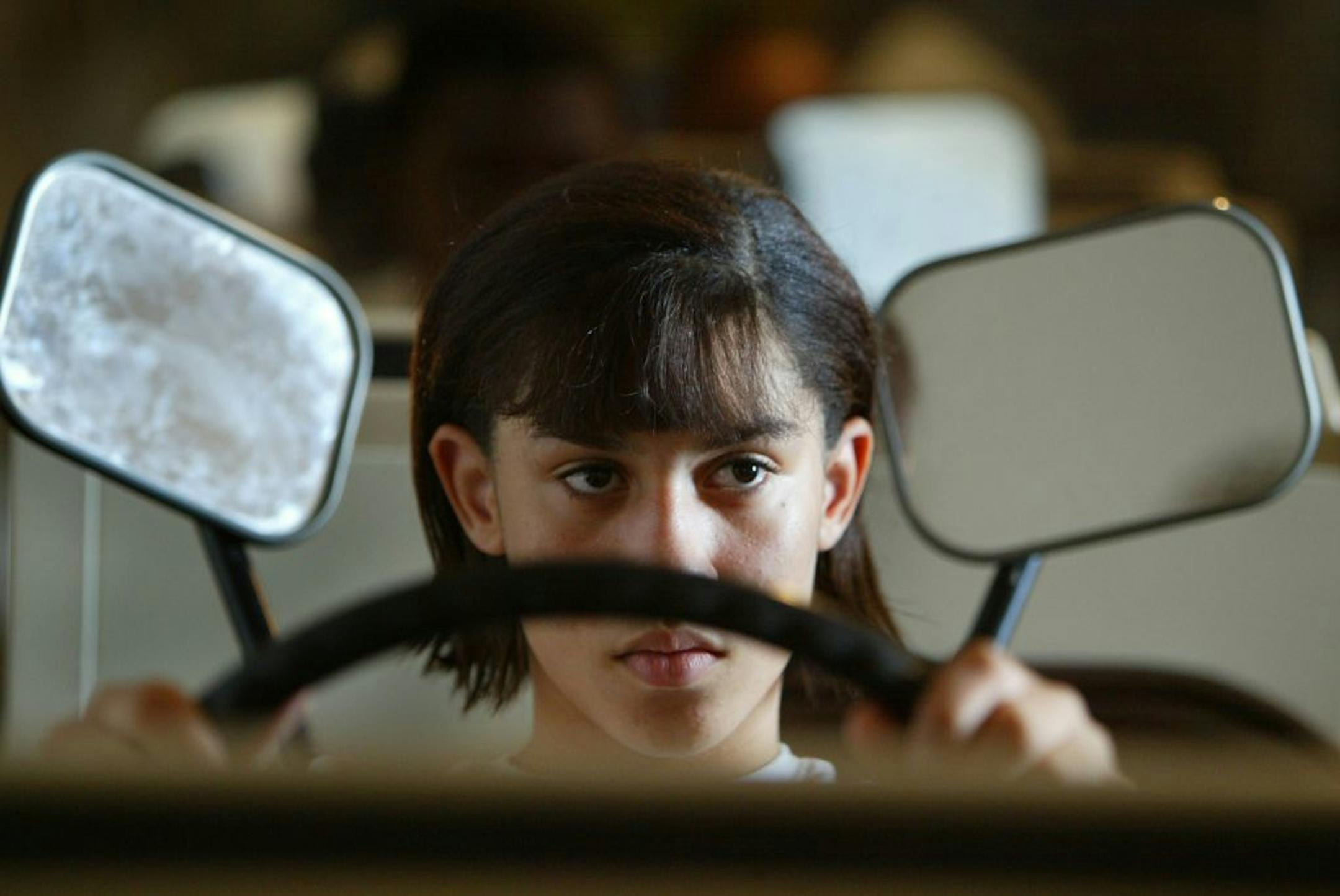 Minneapolis MN. Edison High School 10/14/2003--A drivers education class at Edison puts into use 16 simulators so that studying students may get a 'little' feel to what behind the wheel resembles. Teacher Shirly Rowland, has a movie projector that runs actual footage (on a big white wall) of the drive from the drivers point of view, students are warned that they must watch everything that goes on in front of them and react to different situations as if they were driving on the road. The simulato