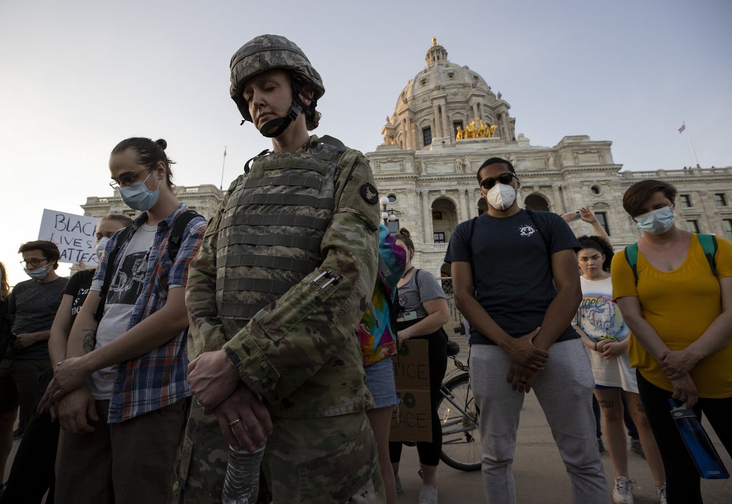 First Lt. Andrea Drost of the Minnesota Army National Guard joined protesters in a moment of prayer at the Capitol in St. Paul on Monday, June 1.