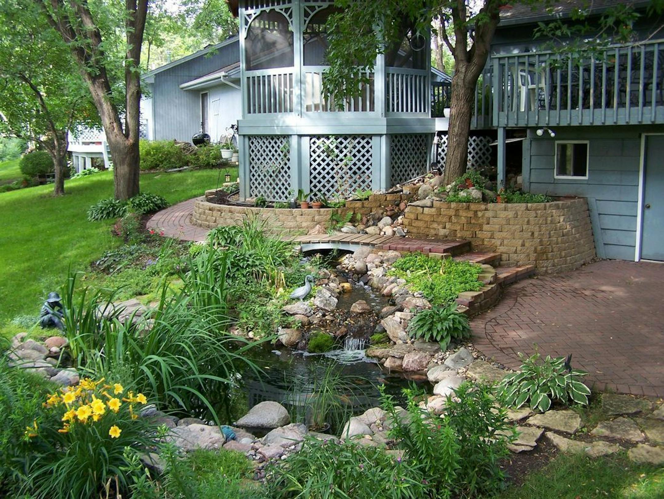 A stream and koi pond off a patio in a Chaska backyard on the MWGS Water Garden Tour, July 27-28.