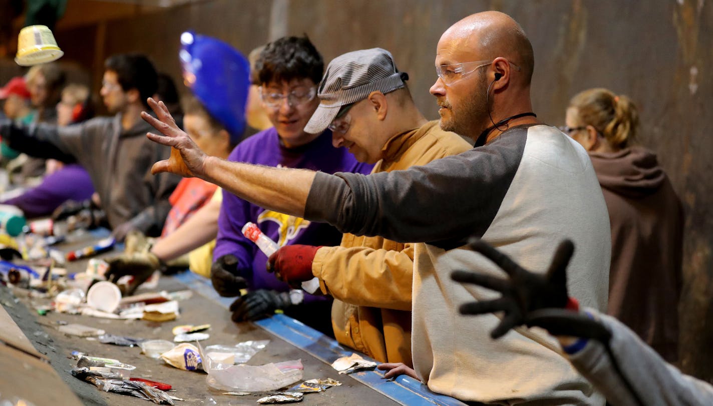 John Week, right, steps in on the recycling sorting line while floating at various jobs at MDI's newly opened plastics fabrication and recycling plant Tuesday, Sept. 27, 2016, in Cohasset, Minn. (David Joles/Minneapolis Star Tribune/TNS) ORG XMIT: 1191425