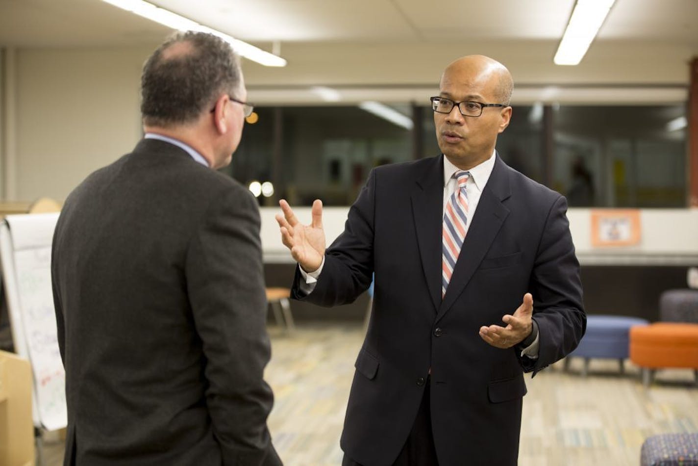 The three final candidates for Minneapolis superintendent met with community members at Webster Elementary on Tuesday, December 2, 2015, in Minneapolis, Minn. In this picture, Interim Superintendent and candidate Michael Goar, right, chatted with a man at a community meet and greet.