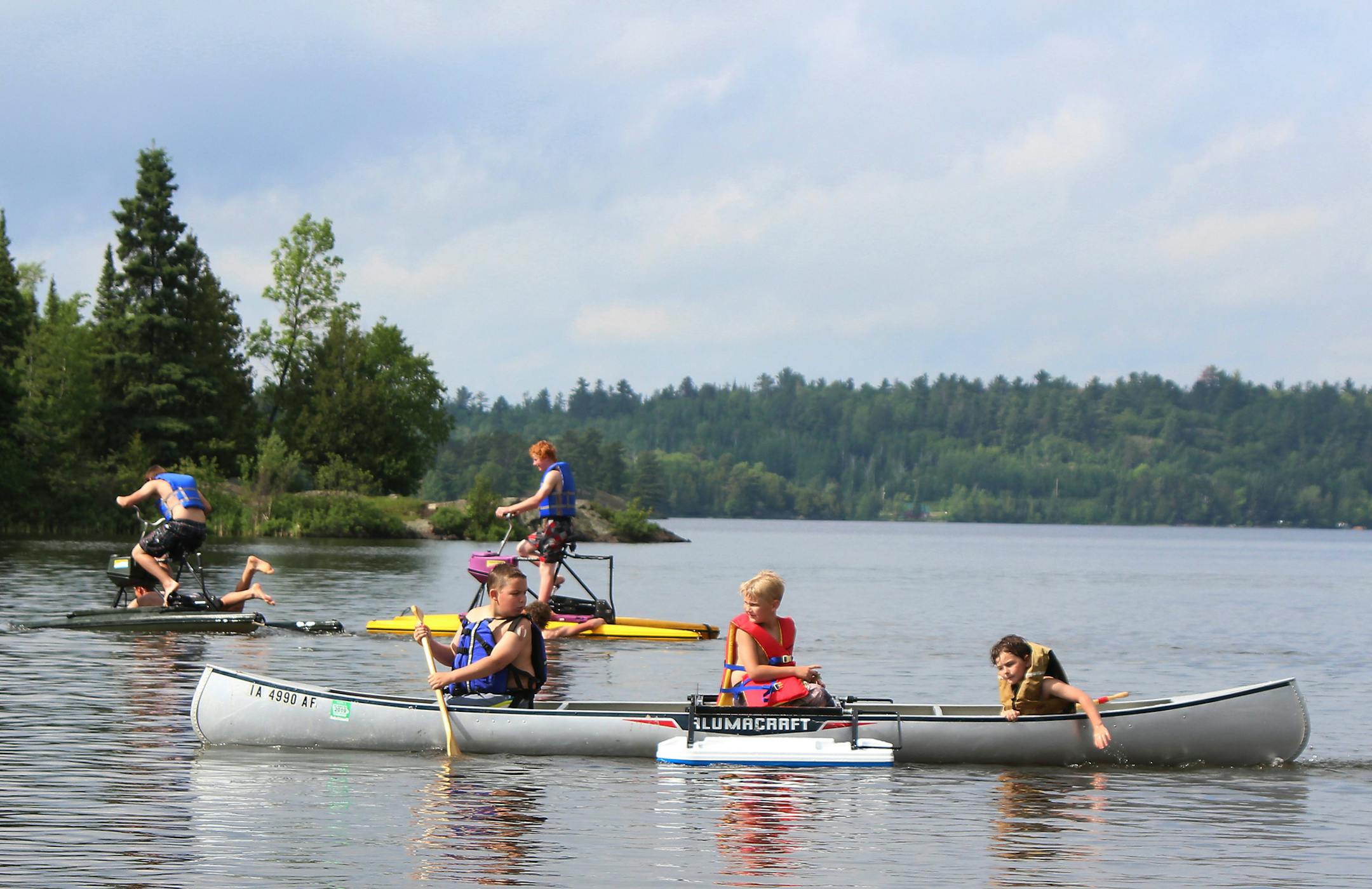 Being in charge also means barking for paddling help. These three crew mates take a free test run in one of the many canoes, kayaks, paddleboards and hydr bikes offered at the Great American Canoe Festival in Ely.