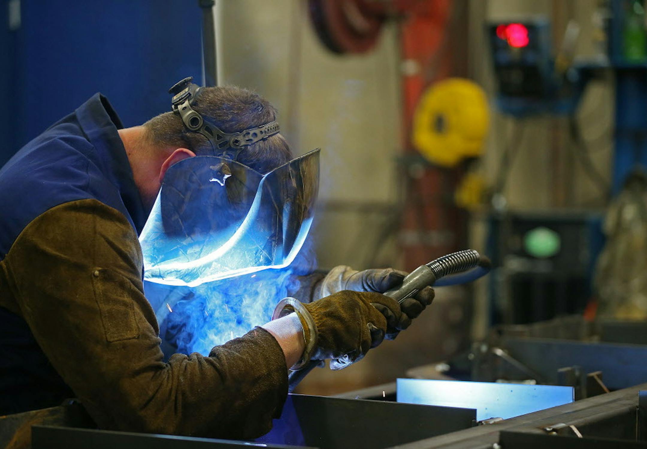 Spencer Hoiland welded together a large cargo-dolly platform at Fast Global Solutions (formerly WASP Inc.), a manufacturer that produces massive expandable conveyer systems and cargo dollies, Wednesday, April 6, 2016 in Glenwood, MN. ] (ELIZABETH FLORES/STAR TRIBUNE) ELIZABETH FLORES • eflores@startribune.com