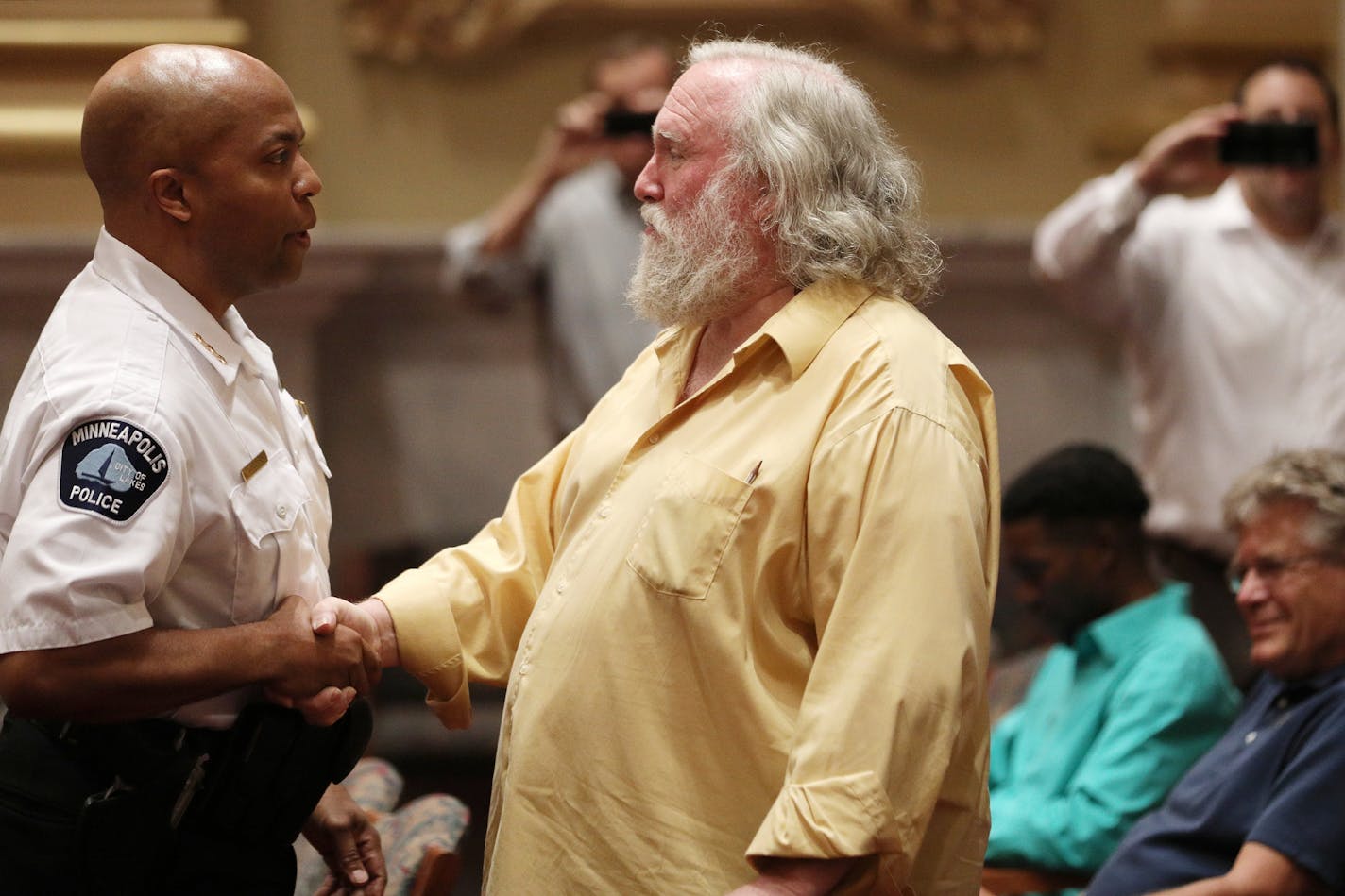 Acting police chief Medaria Arrodondo shook hands with Dave Bicking, a long-time police critic with Communities United Against Police Brutality, prior to Tuesday's meeting of the Minneapolis City Council executive committee.