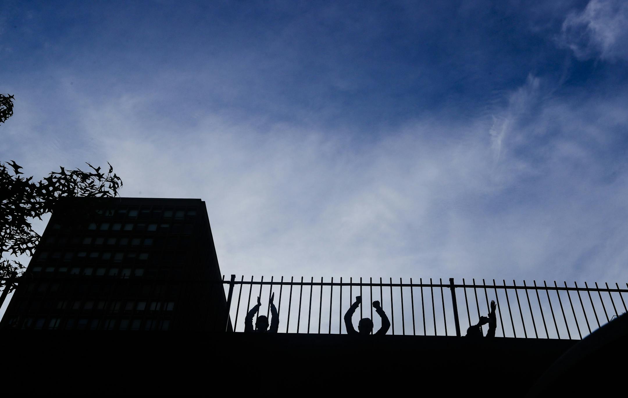 People cheer for medical workers at 7 p.m. amid the coronavirus pandemic, Tuesday, May 19, 2020, in New York. (AP Photo/Frank Franklin II)