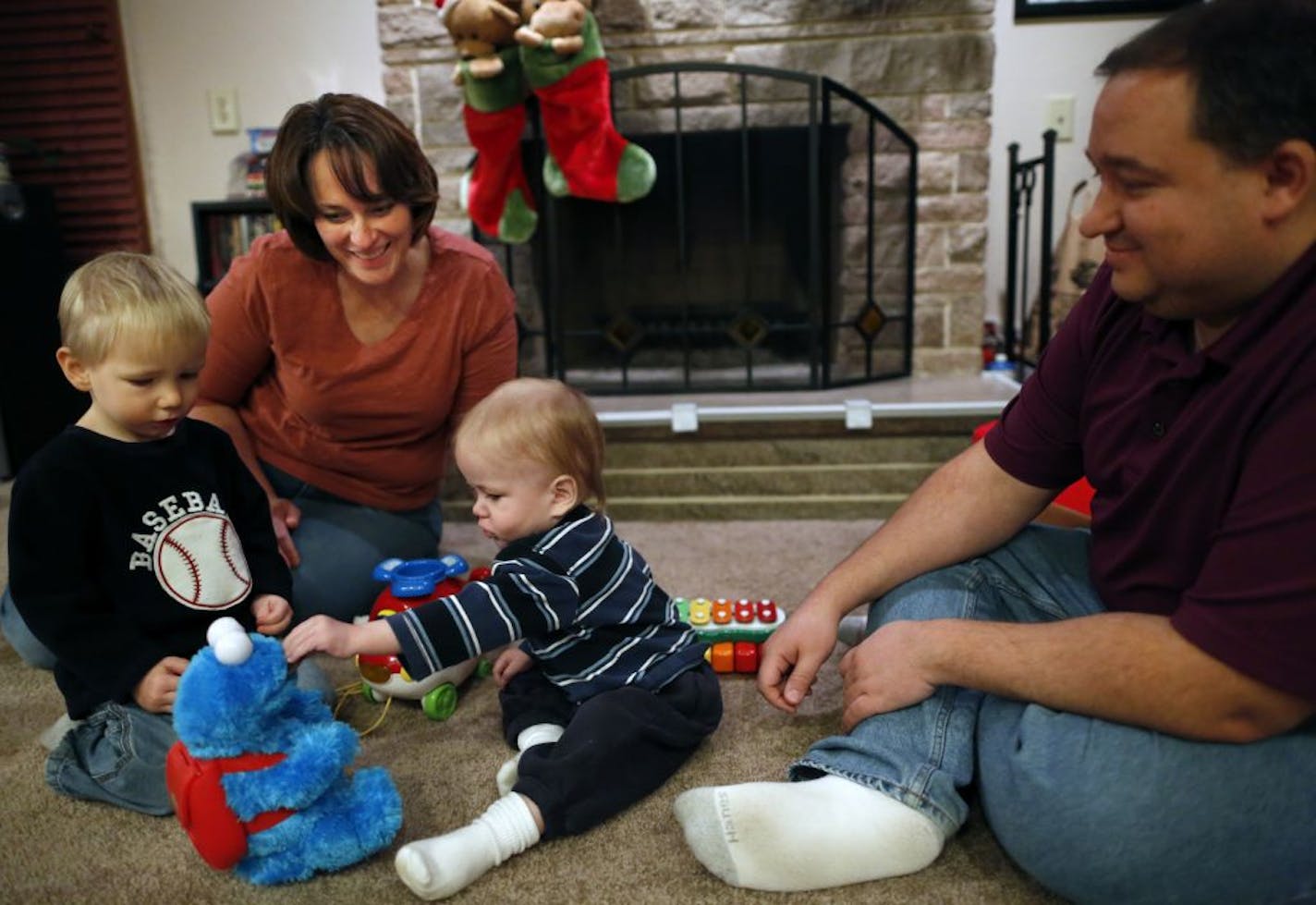 Kathy and Alan Carda now have adopted two children from Russia. Three-year-old Aleks, at left, is helping his new brother, Georgiy, 18 months, get settled in the family's Highland Park home.