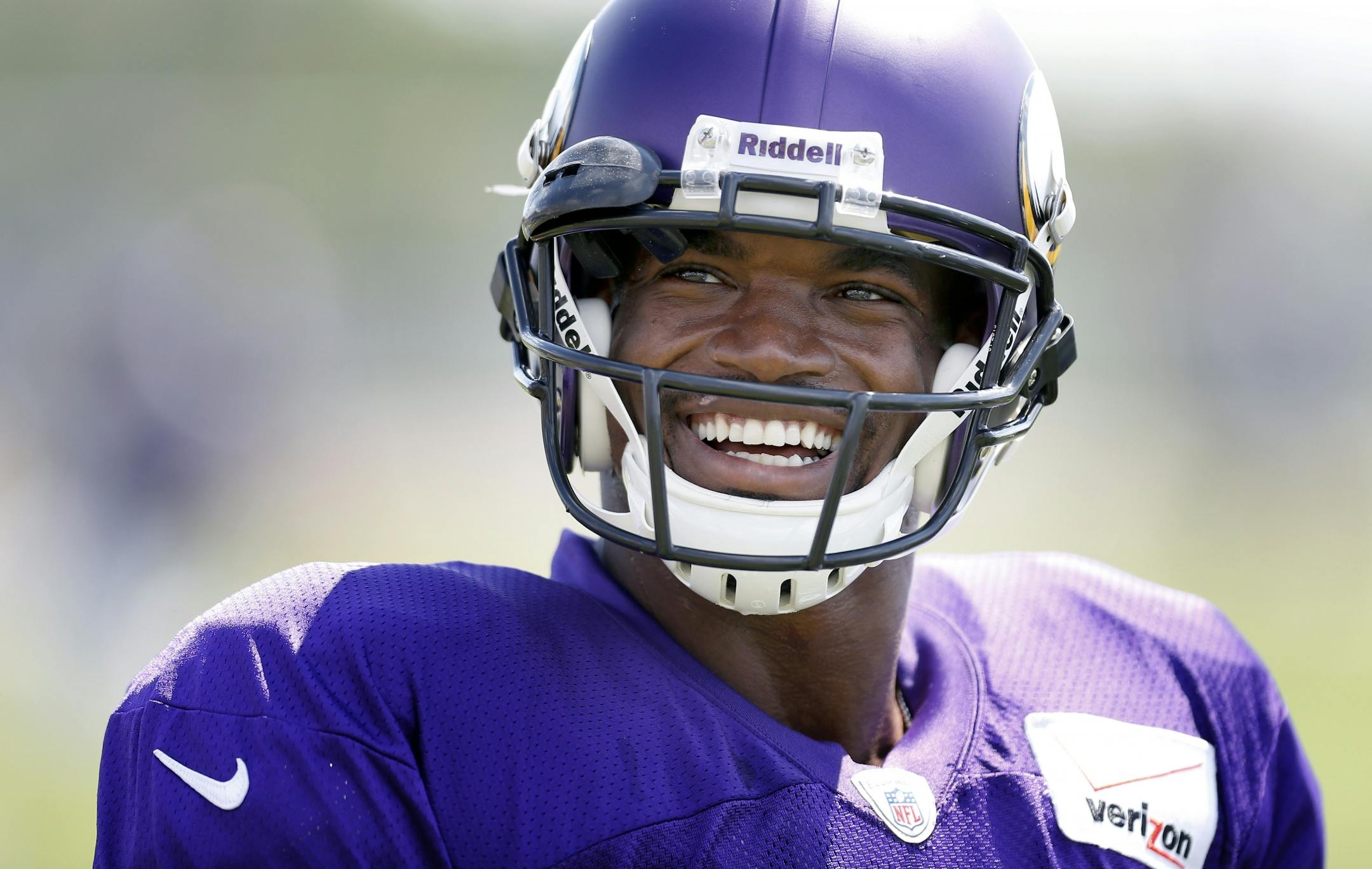 Minnesota Vikings running back Adrian Peterson (28) cracked a smile after hearing his name repeatedly called by a young fan in the stands during practice on Wednesday.