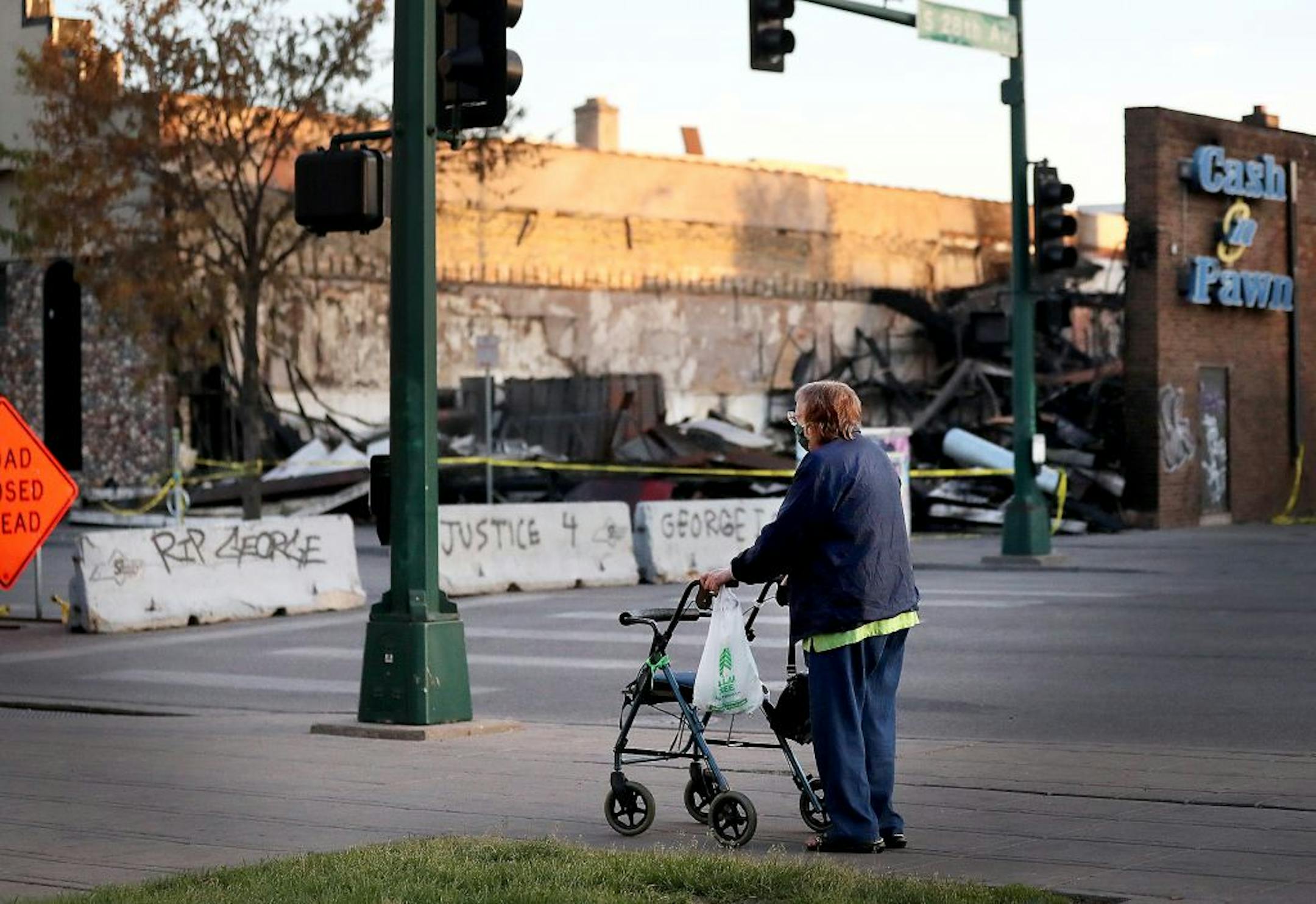 Ruth Odren, 87, ventured outside her nearby apartment to look at damage near Lake St. and S. 28th Ave. Odren said she is self-isolating because of the coronavirus and has rarely left her apartment since mid-March.
