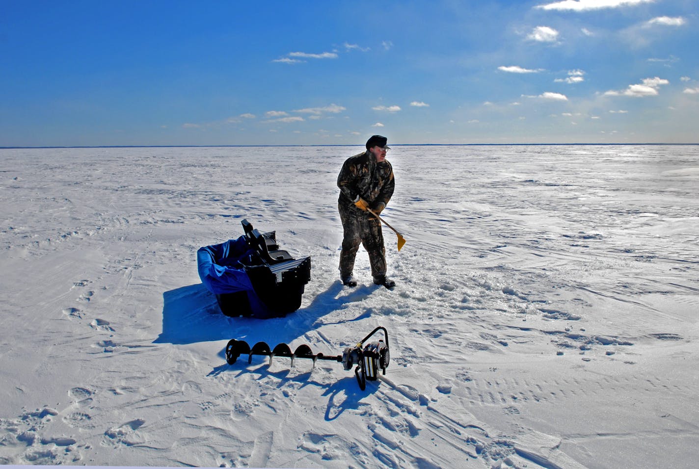 With the temperature about zero degrees Thursday afternoon and a stiff wind out of the northwest, Department of Natural Resources large lakes specialist Gerry Albert of Grand Rapids prepared to fish perch on Lake Winnibigoshish. The frigid weather has kept the ice very thick, even into March.