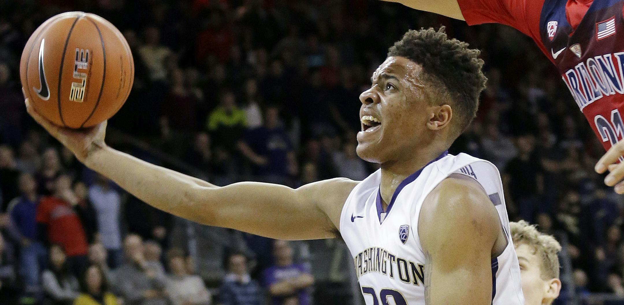 FILE - In this Feb. 18, 2017, file photo, Arizona's Chance Comanche, right, defends as Washington's Markelle Fultz's (20) looks for a shot during the second half of an NCAA college basketball game, in Seattle. Fultz is the likely No. 1 pick in the NBA Draft on Thursday night, June 22. (AP Photo/Elaine Thompson, File) ORG XMIT: NY158