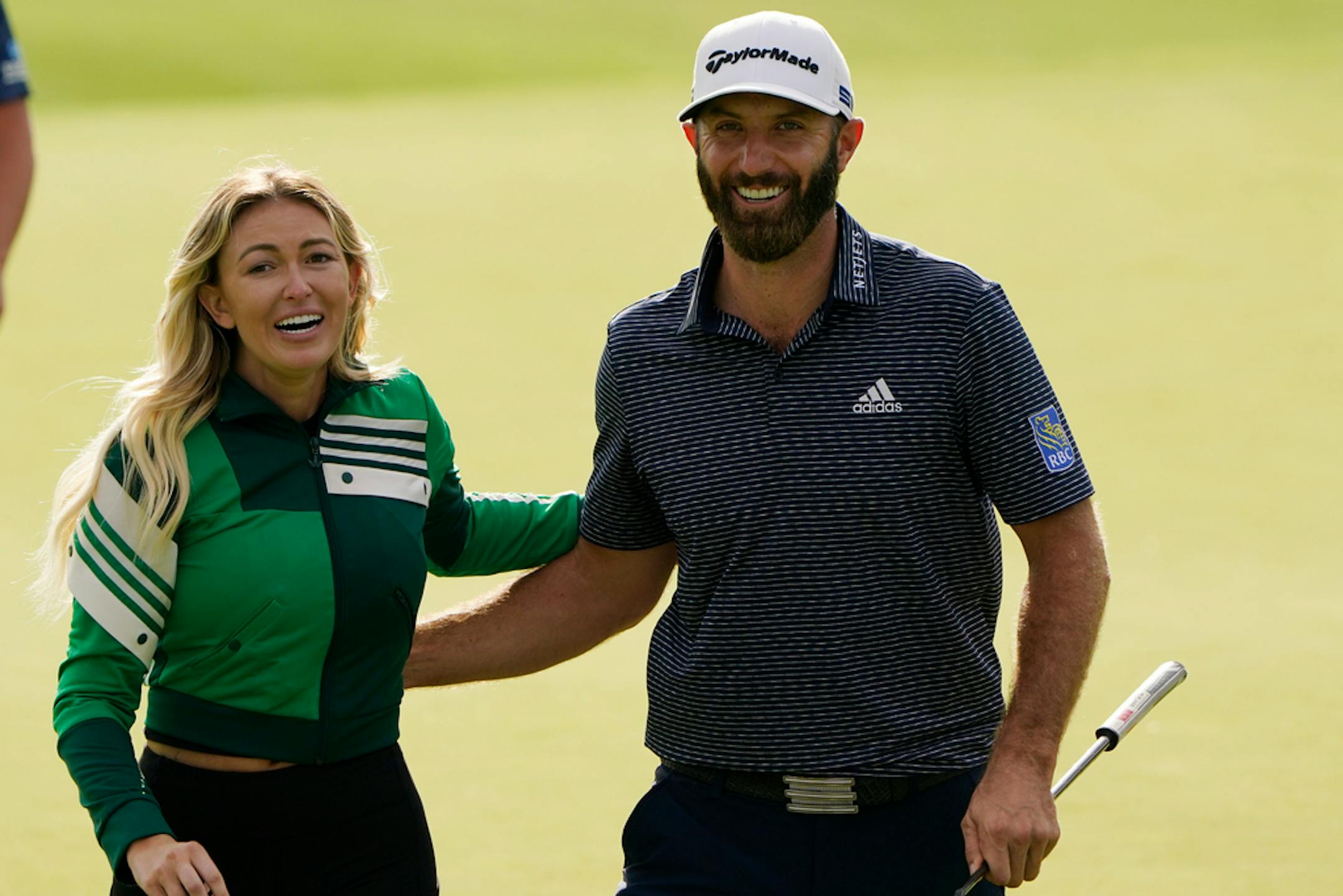 Dustin Johnson walks with his wife, Paulina Gretzky, after winning the Masters golf tournament Sunday, Nov. 15, 2020, in Augusta, Ga. (AP Photo/Chris Carlson)