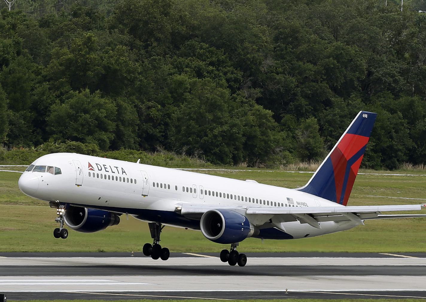 FILE - In this Thursday, May 15, 2014, file photo, a Delta Air Lines Boeing 757-232 lands at the Tampa International Airport in Tampa, Fla. (AP Photo/Chris O'Meara, File)