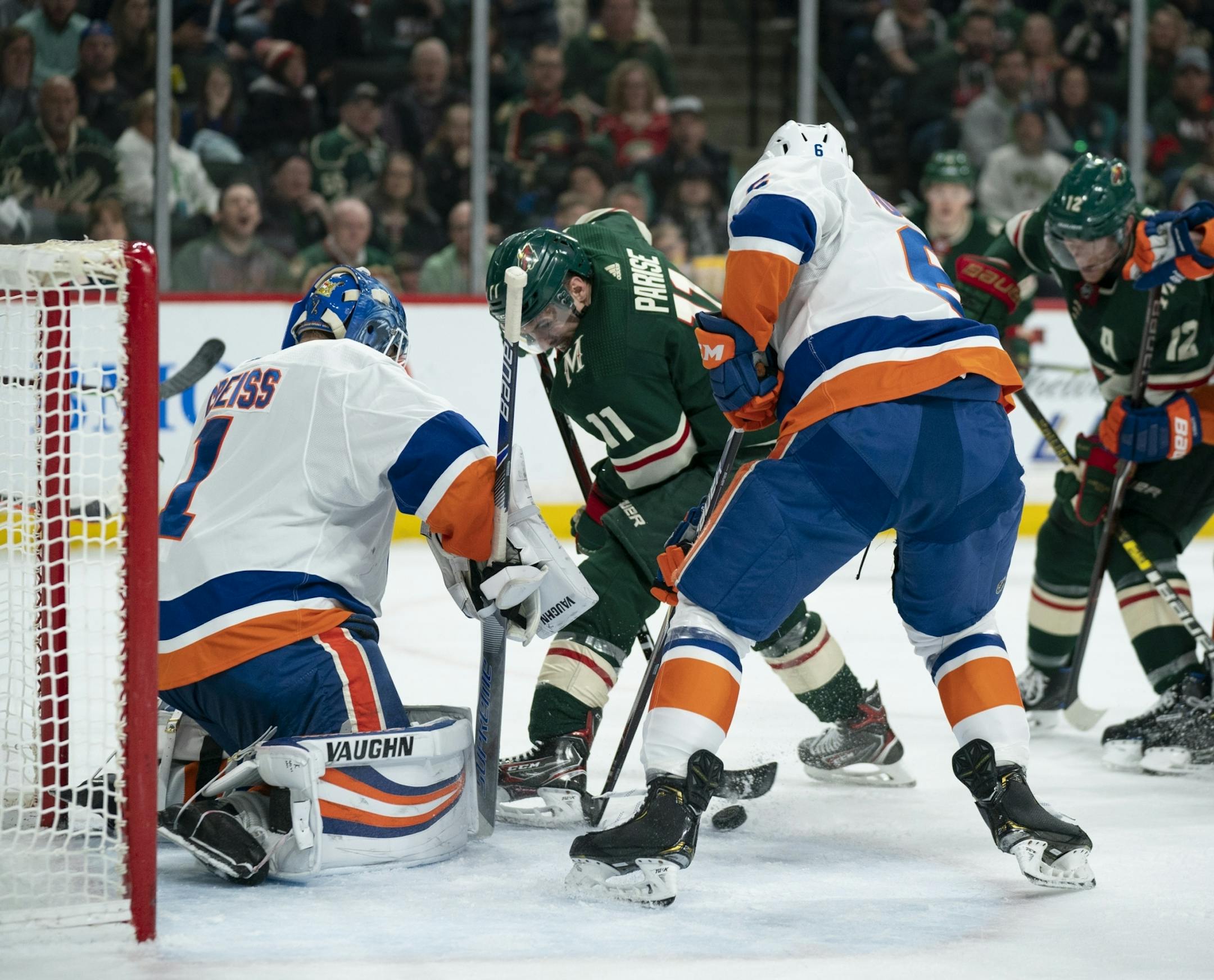 Minnesota Wild left wing Zach Parise (11) stuffed the puck past New York Islanders goaltender Thomas Greiss (1) in the second period to tie the game 1-1.