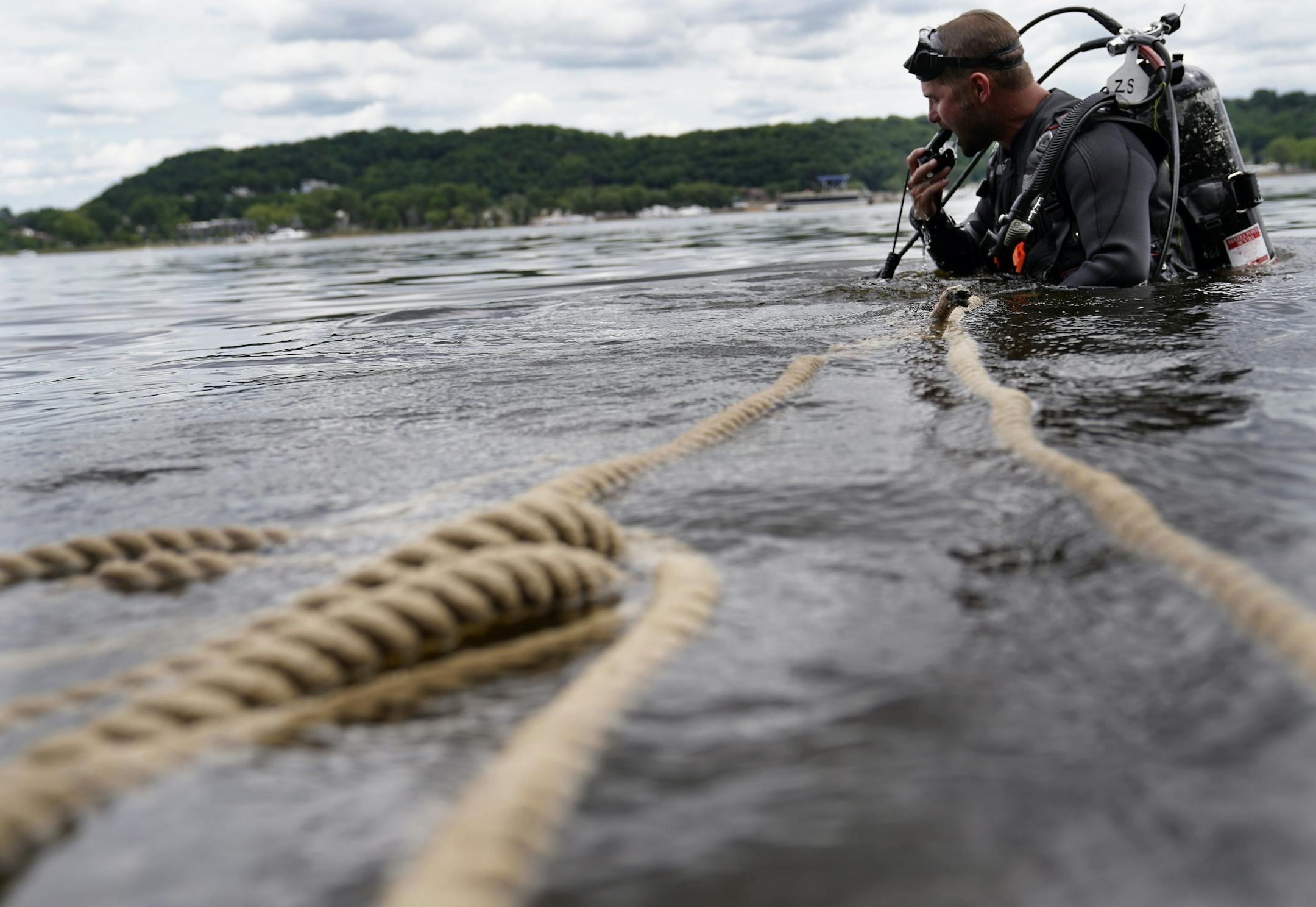 A Minnesota DNR crew transplanted 3,506 mussels native to Minnesota -- including Higgins' eye, bucket and snuffbox-- to grow in the waters of the St. Croix River, across from Hudson, WI, Tuesday in Lakeland, MN. Here, Minnesota Department of Natural Resources crew member Zeb Secrist, Minnesota DNR natural resources specialist, searches the river for mussels that were transplanted last year in the St. Croix.