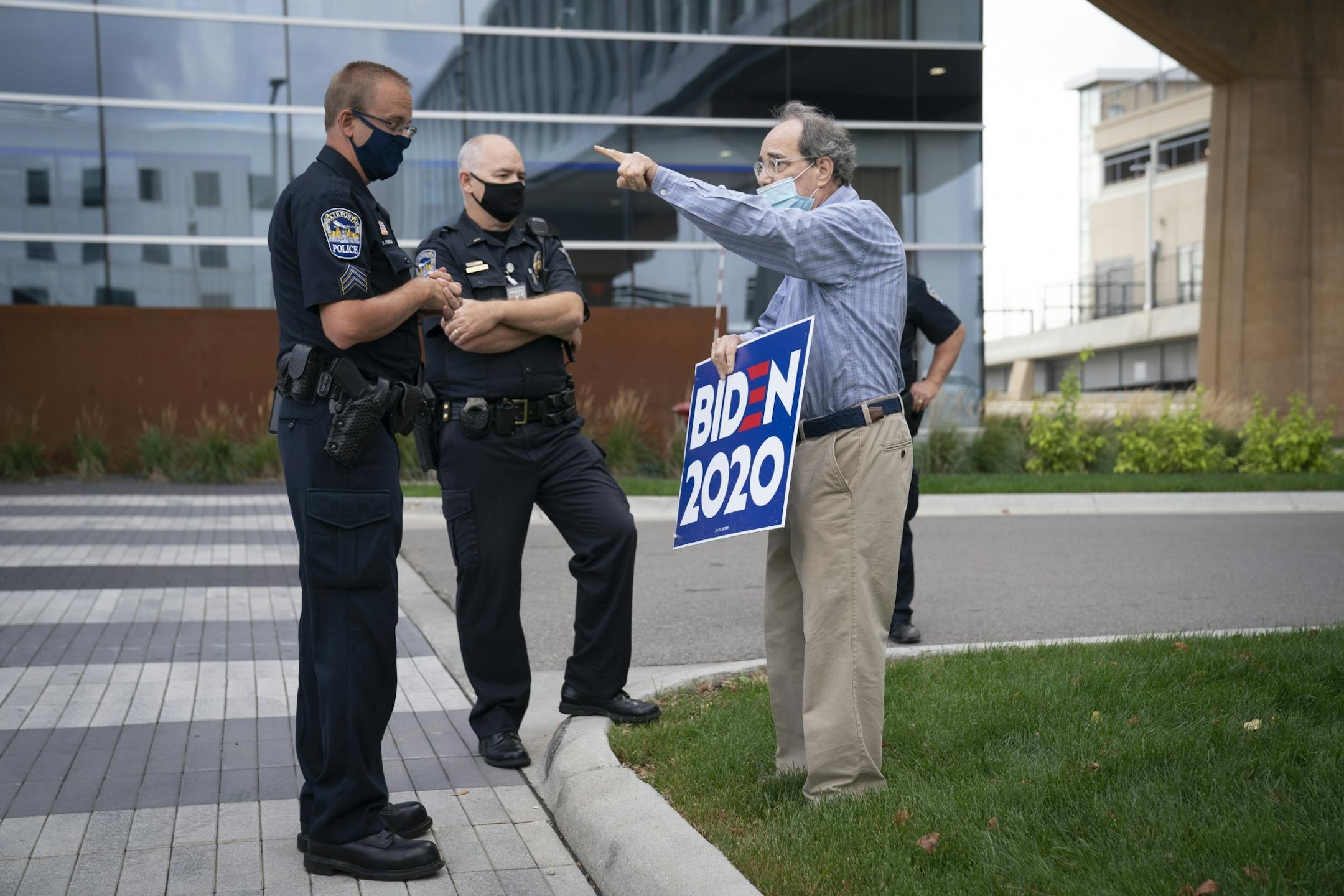 Security argued with a man holding a BNiden 2020 sign where public property was outside a 'Cops for Trump' listening session with Vice President Mike Pence and Ivanka Trump at the InterContinental Minneapolis-St. Paul in Minneapolis, Minn., on Thursday, September 24, 2020.