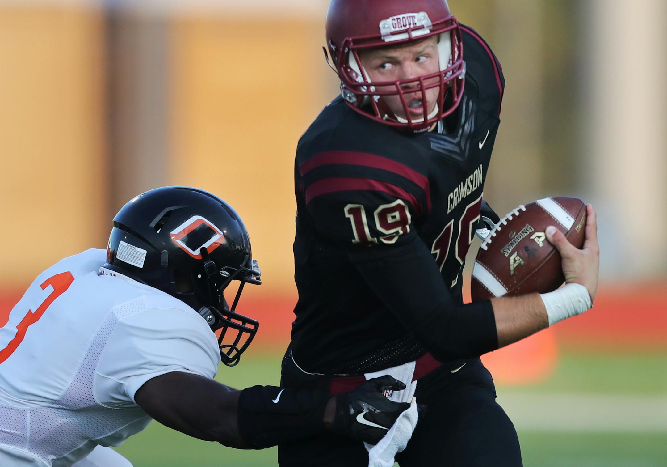 Maple Grove QB Brad Davdson escapes the grasp of LB Adeyinka Omotoyinbo(3) .]At Maple Grove H.S. in the home opener against Osseo H.S.RichardTsong-Taatarii richard.tsong-taatarii@startribune.com