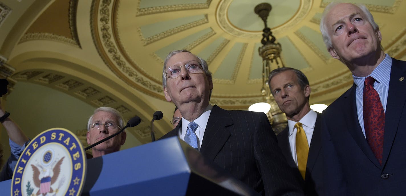 FILE - In this Sept. 13, 2016 file photo, Senate Majority Leader Mitch McConnell of Ky., second from left, standing with, from left, Sen. Roger Wicker, R-Miss., Sen. John Thune, R-S.D., and Senate Majority Whip John Cornyn, of Texas, listens to a question during a news conference on Capitol Hill in Washington. The White House lashed out at Congress on Thursday, Sept. 29, 2016, a day after Republicans and Democrats overwhelmingly overrode President Barack Obama&#xed;s veto of a bill to allow fami