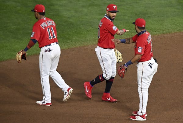 Minnesota Twins shortstop Jorge Polanco (11), outfielder Eddie Rosario (10) and second baseman Luis Arraez (2) celebrated their 3-0 victory against th