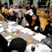 Minneapolis City Council Member Aurin Chowdhury, center, brainstorms community safety ideas for Lake Street and south Minneapolis with her table at a 