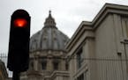 A traffic light is seen outside the Perugino Gate at the Vatican, Thursday, Sept. 13, 2018. A delegation of U.S. Catholic cardinals and bishops met Th