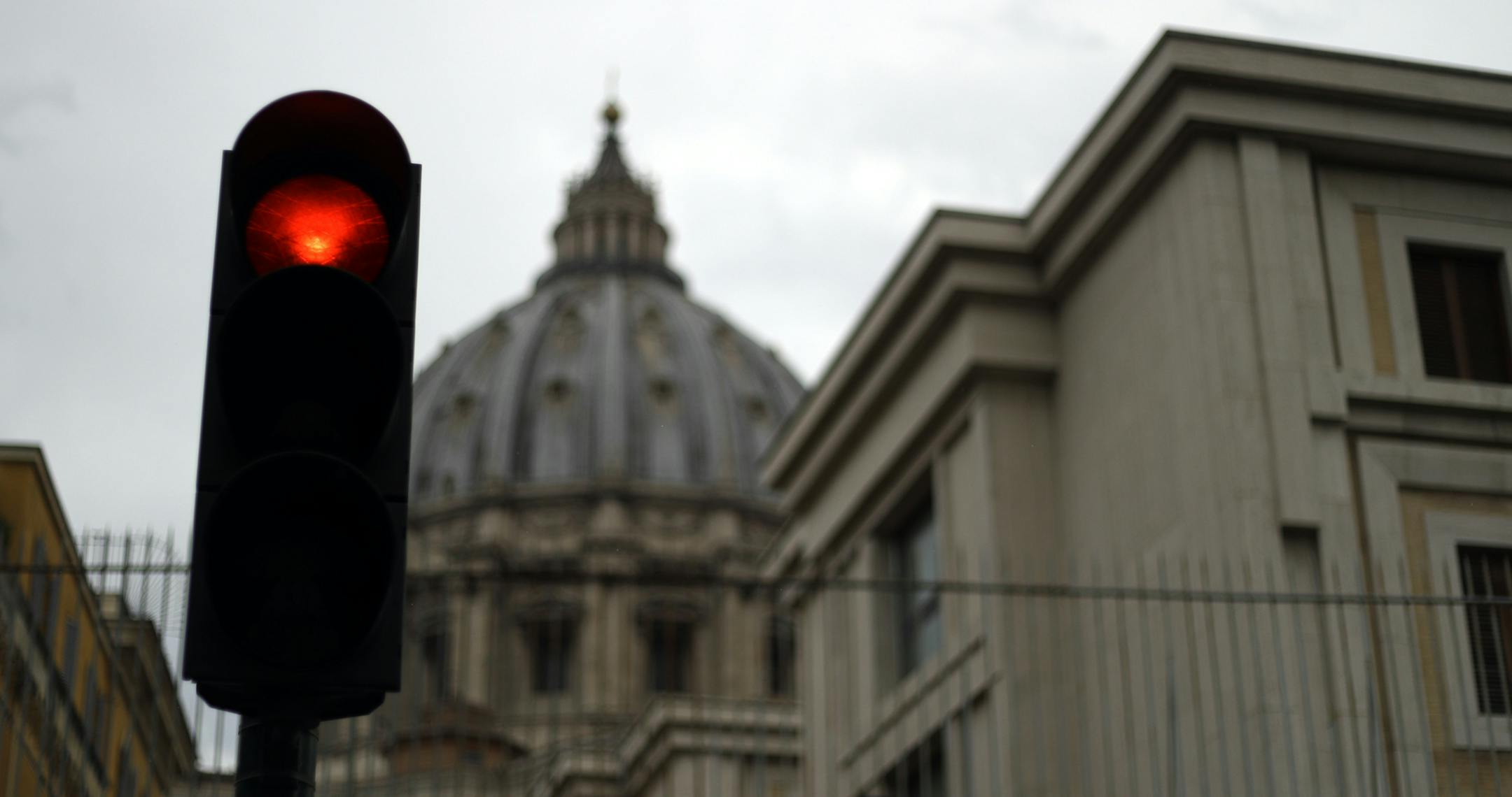 A traffic light is seen outside the Perugino Gate at the Vatican, Thursday, Sept. 13, 2018. A delegation of U.S. Catholic cardinals and bishops met Thursday with Pope Francis amid a crisis of confidence in church leadership following new sex abuse and cover-up revelations that have also implicated Francis himself. (AP Photo/Gregorio Borgia)