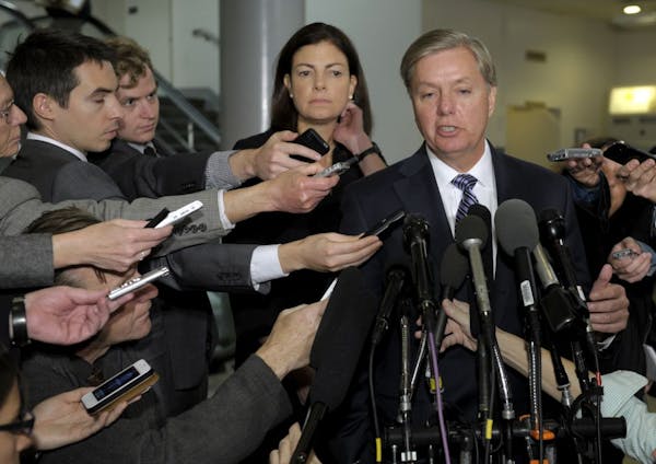 Senate Armed Services Committee members, Sen. Lindsey Graham, R-S.C., foreground, and Sen. Kelly Ayotte, R-N.H., speaks to reporters on Capitol Hill i