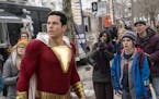 This image released by Warner Bros. shows Zachary Levi, left, and Jack Dylan Grazer in a scene from "Shazam!" (Steve Wilkie/Warner Bros. Entertainment