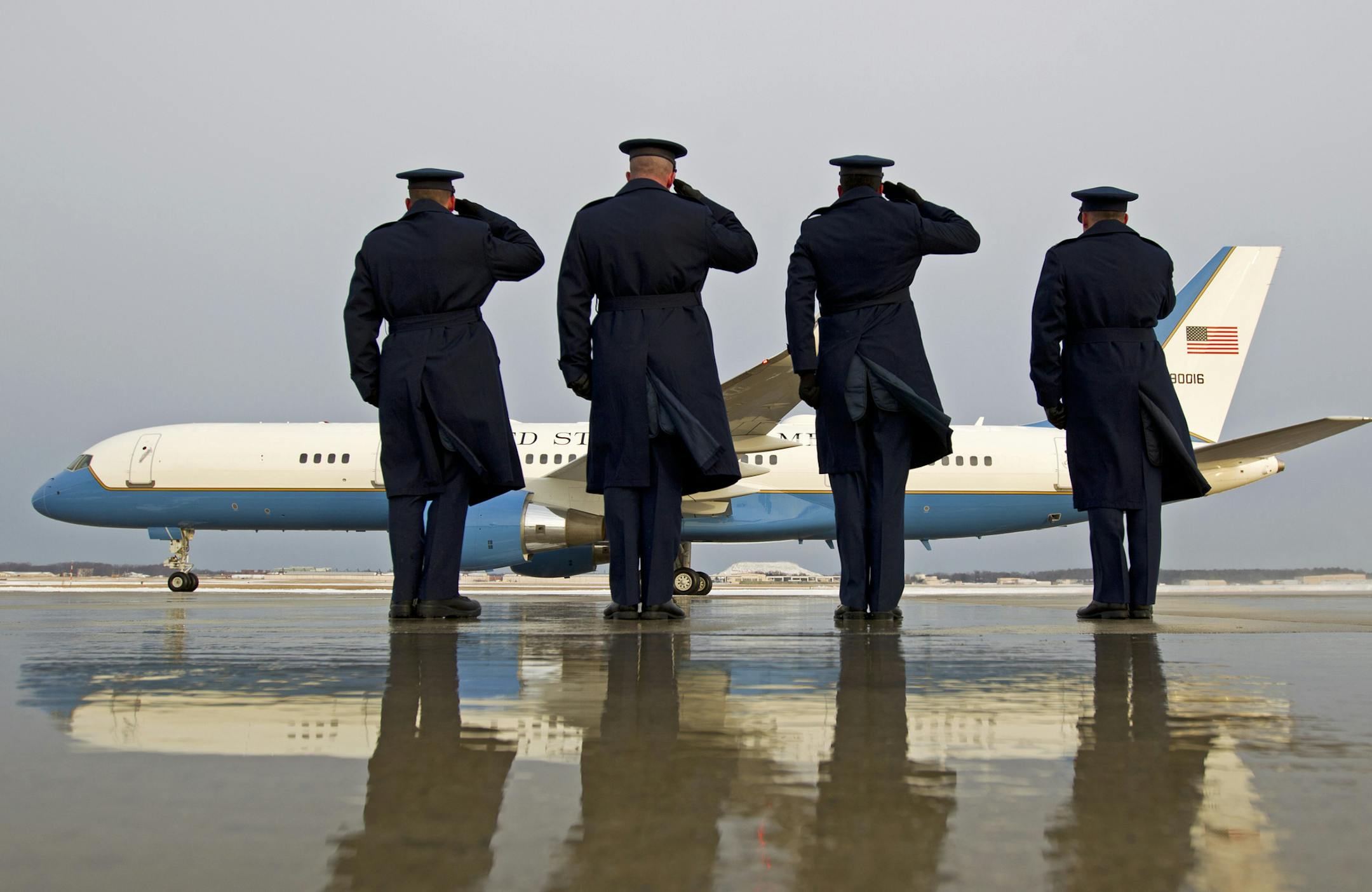 Military personnel salute as Air Force One with President Barack Obama aboard, departs at Andrews Air Force Base, Md., Saturday, Jan. 7, 2017, en route to Jacksonville, Fla., to attend a wedding. ( AP Photo/Jose Luis Magana)