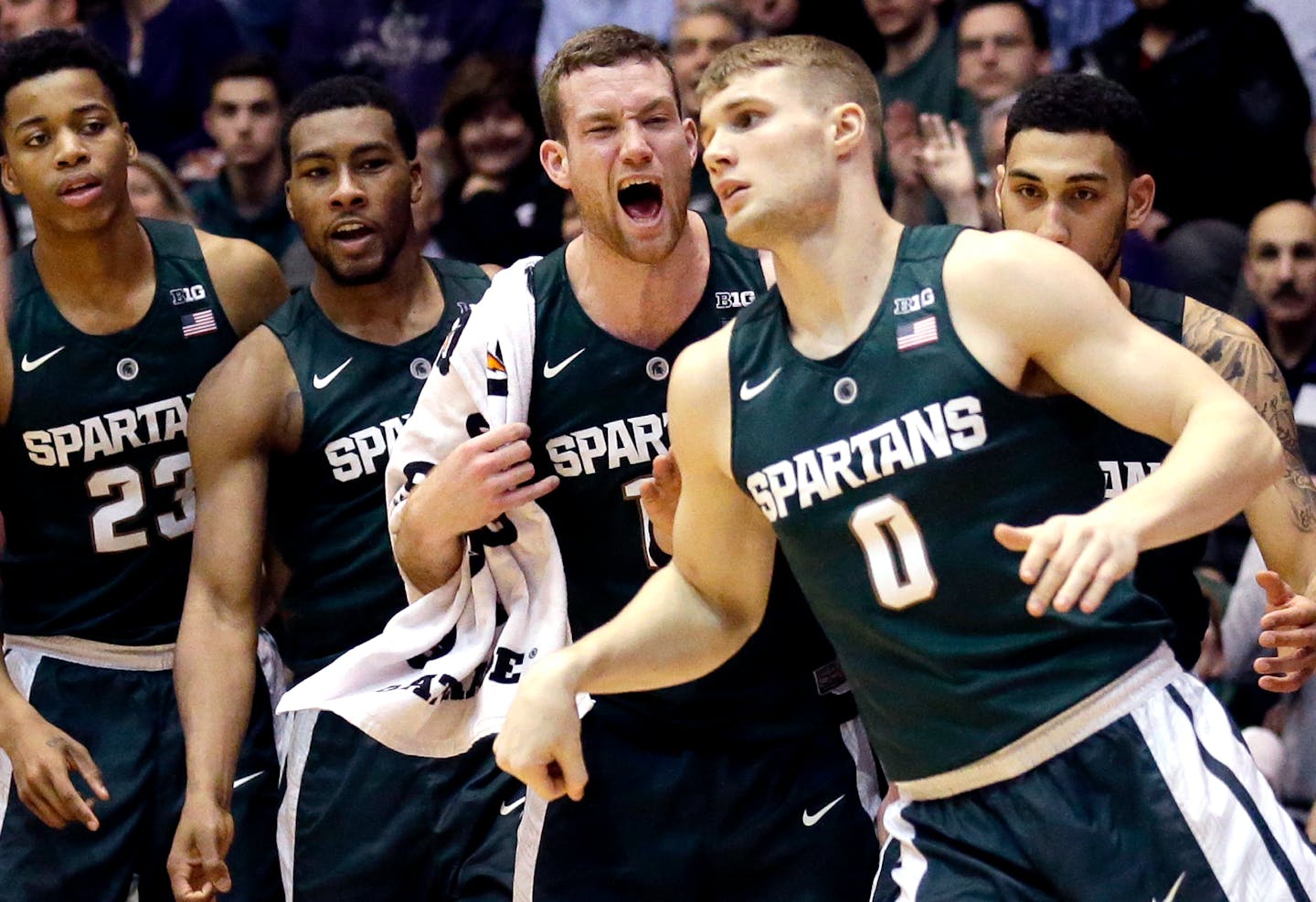 Michigan State forward Deyonta Davis (23), forward Javon Bess, second from left, forward Matt Costello, third from left, and guard Denzel Valentine, right, celebrate after guard Kyle Ahrens (0) scored a basket during the second half of an NCAA college basketball game against Northwestern, Thursday, Jan. 28, 2016, in Evanston, Ill. Michigan State won 76-45. (AP Photo/Nam Y. Huh)