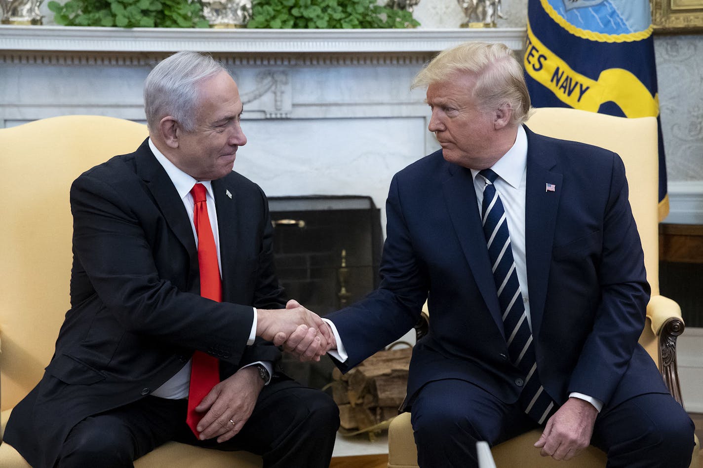 President Donald J. Trump, right, shakes hands with Prime Minister of Israel Benjamin Netanyahu during a meeting in the Oval Office of the White House, in Washington, D.C., on Jan. 27, 2020.