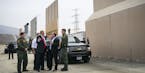 FILE-- President Donald Trump views border wall prototypes in the border neighborhood of Otay Mesa near San Diego, March 13, 2018. Trump has called fo