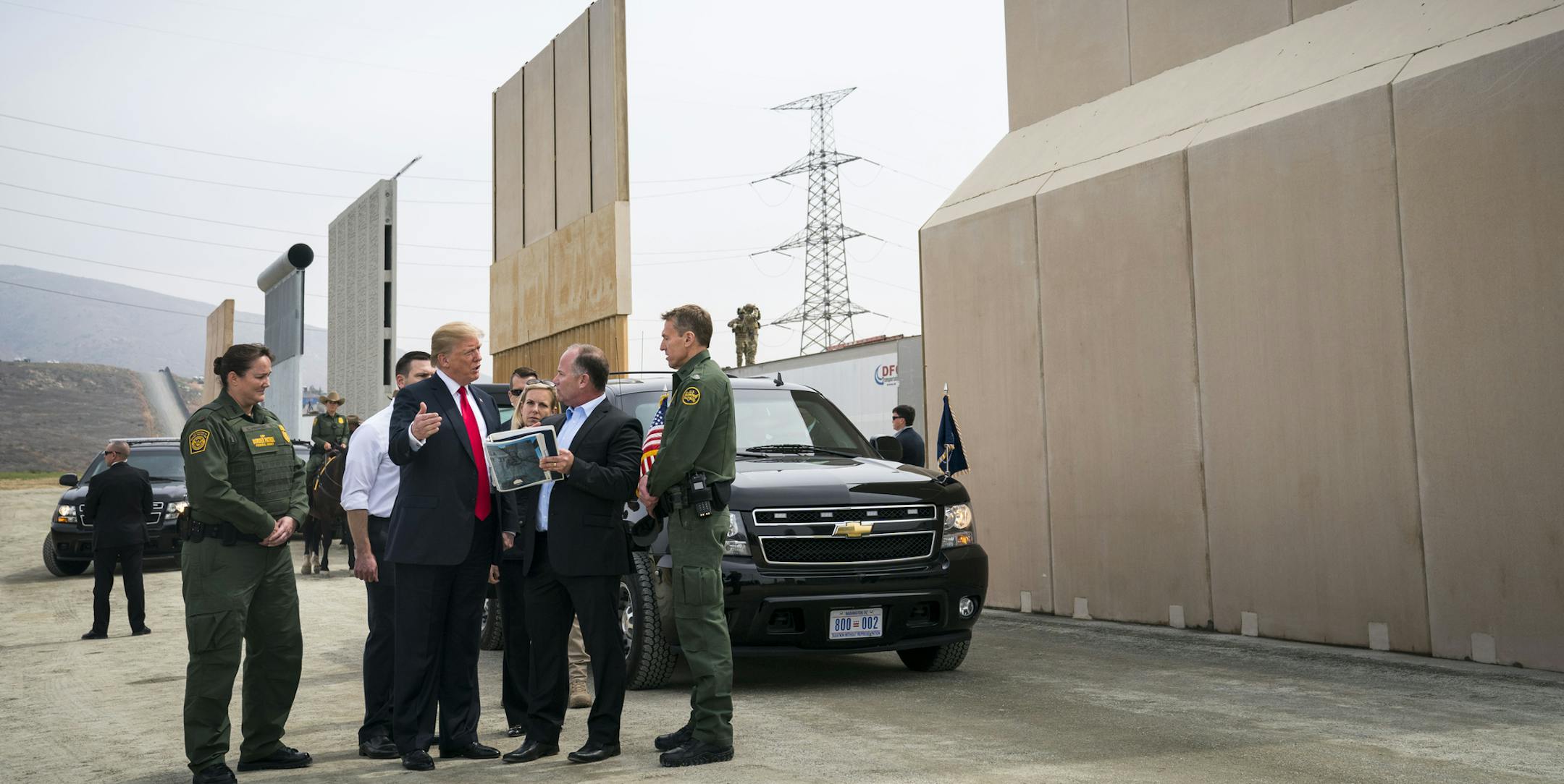 FILE-- President Donald Trump views border wall prototypes in the border neighborhood of Otay Mesa near San Diego, March 13, 2018. Trump has called for a wall along the border with Mexico to stop undocumented immigrants and drugs from entering the U.S. But Border Patrol agents on the front lines say they need more technology and additional personnel to curb the illegal traffic, according to a report released on Thursday by Democrats on the Senate Homeland Security Committee. (Doug Mills/The New