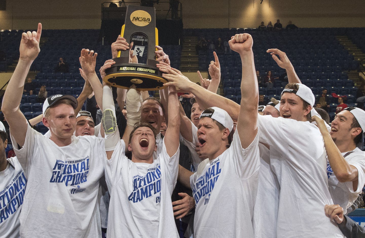 University of St. Thomas players Thomas Sjoberg, Grant Shaeffer, Will Dunn, Jodan Burich and G.T. Johnson celebrate after St. Thomas won the NCAA Division III men's college basketball championship game in March. The Tommies also finished second in NCAA D-III football.