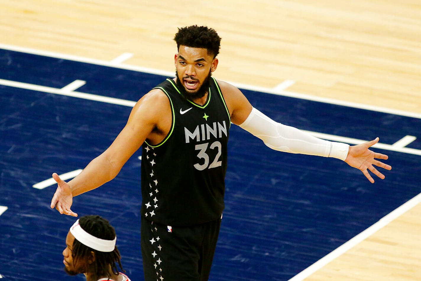 Minnesota Timberwolves center Karl-Anthony Towns (32) protests a call in the fourth quarter during an NBA basketball game against the Houston Rockets, Friday, March 26, 2021, in Minneapolis. (AP Photo/Andy Clayton-King)