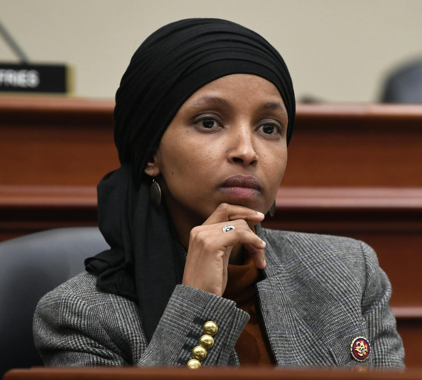 File- This March 12, 2019, file photo shows Rep. Ilhan Omar, D-Minn., listening as Office of Management and Budget Acting Director Russell Vought testifies before the House Budget Committee on Capitol Hill in Washington. A Minnesota campaign finance board says Omar violated state rules when she used campaign funds to pay for personal out-of-state travel and help on her tax returns. The Minnesota Campaign Finance and Public Disclosure Board said Thursday, June 6, 2019, that Omar must reimburse he