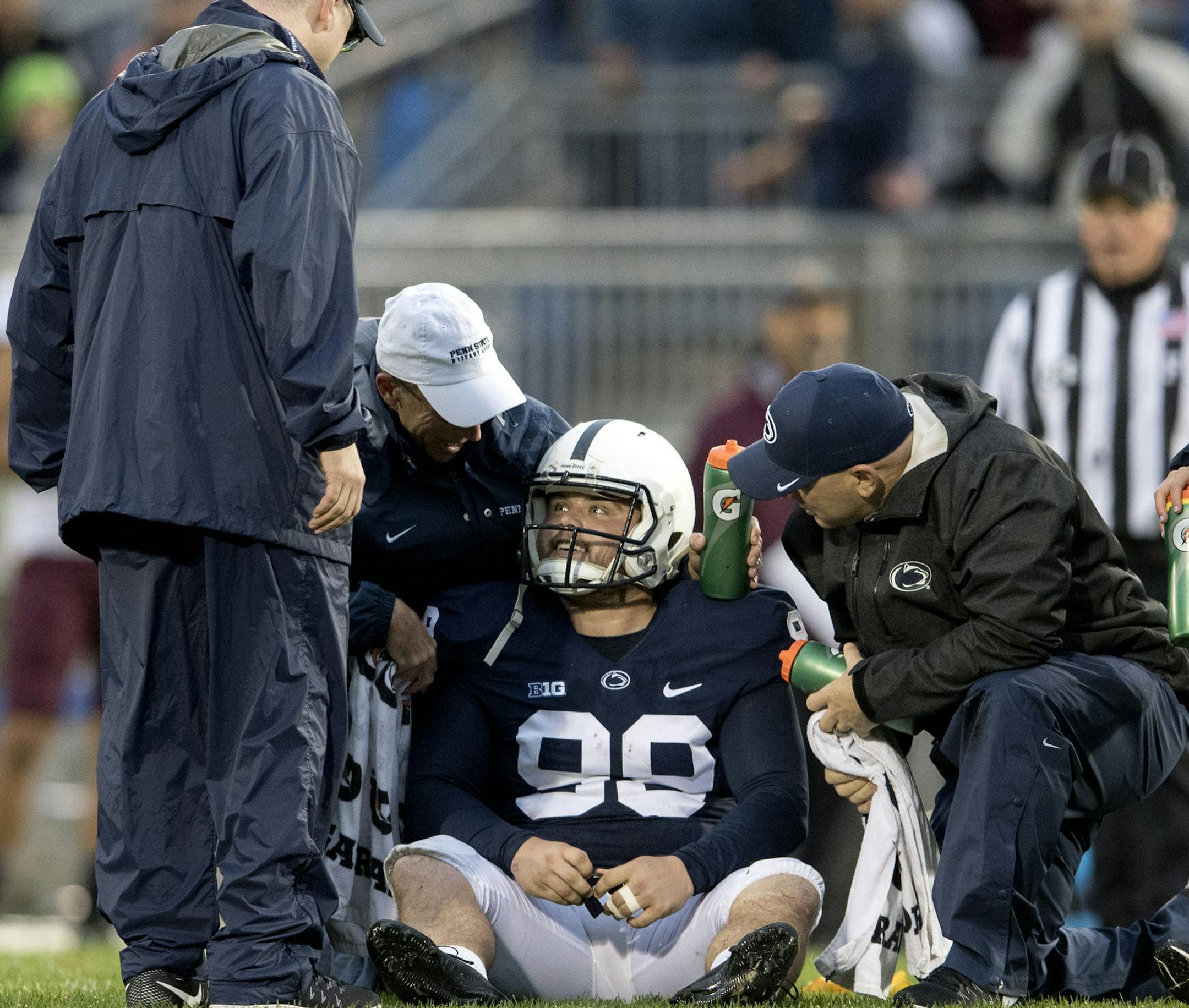 Trainers talk to Penn State kicker Joey Julius after he got hit by Minnesota linebacker Jaylen Waters after a kick off at Beaver Stadium in State College, Pa., on Saturday, Oct. 1, 2016. Waters drew a targeting penalty on the play. (Abby Drey/Centre Daily Times/TNS) ORG XMIT: 1191015