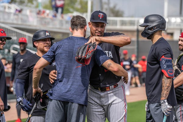 Twins catcher Christian Vazquez looks on as right fielder Max Kepler hugged relief pitcher Jhoan Duran after batting practice in Fort Myers.