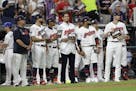 Cleveland Indians pitcher Carlos Carrasco, stands with Indians teammates during the fifth inning of the MLB baseball All-Star Game, Tuesday, July 9, 2