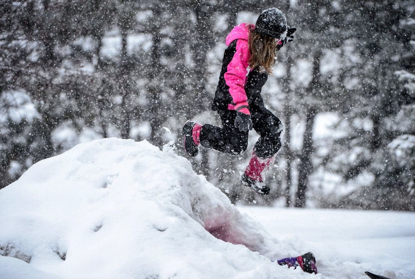 Sisters Emma, 3, and Alexis Cahill, 8, played in the snow at their Apple Valley home Tuesday while their dad Chad shoveled the driveway. They tried digging a hole in a huge pile of snow to make a little snow cave, and then Alexis jumped off the top.