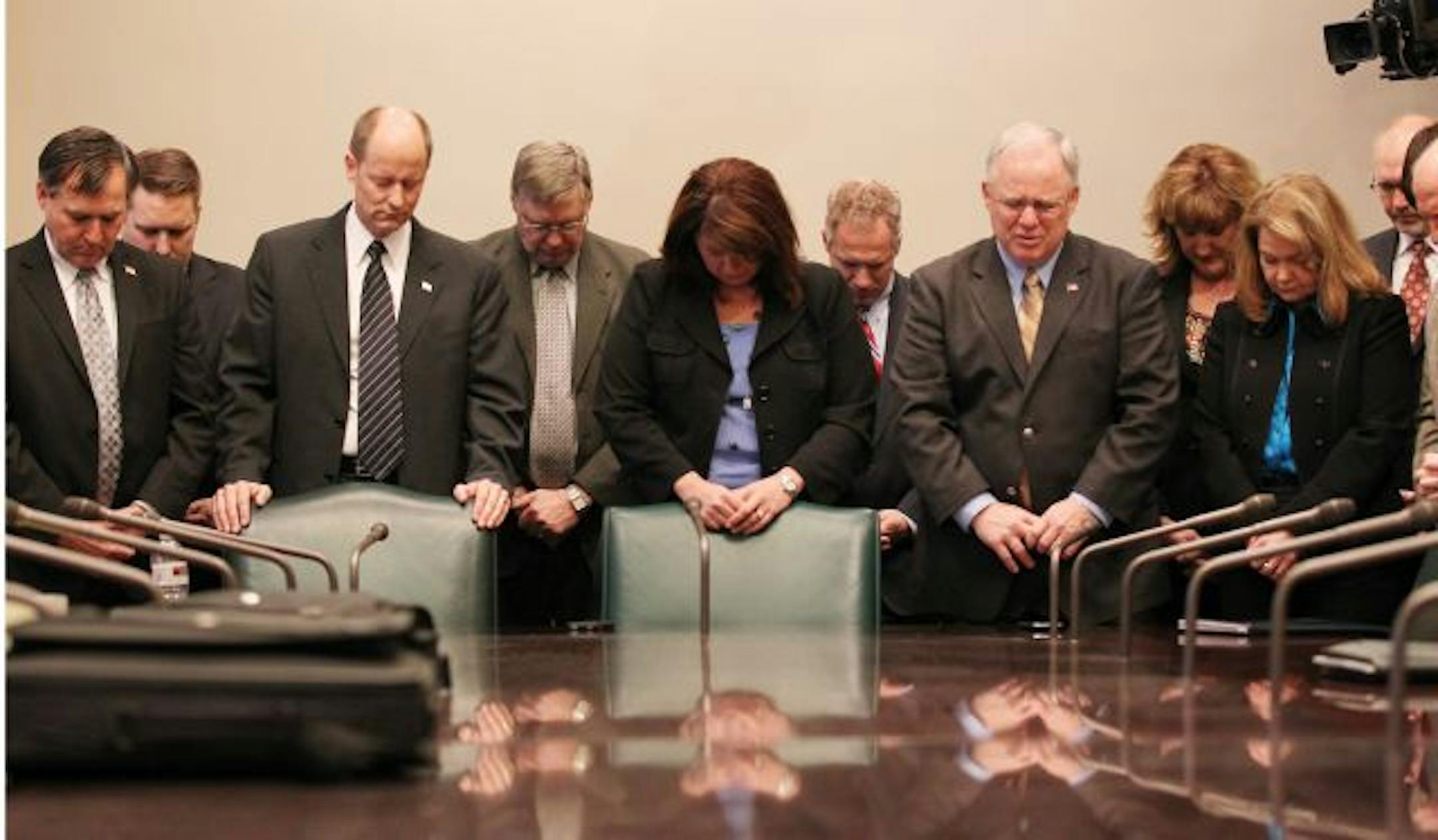 Senate Majority Leader Amy Koch, center, and other state senators were among those observing a moment of silence for victims of a shooting rampage that critically injured a congresswoman and killed six others in Tucson, Ariz., Saturday. Gov. Mark Dayton and legislative leaders will meet to assess security at the State Capitol.