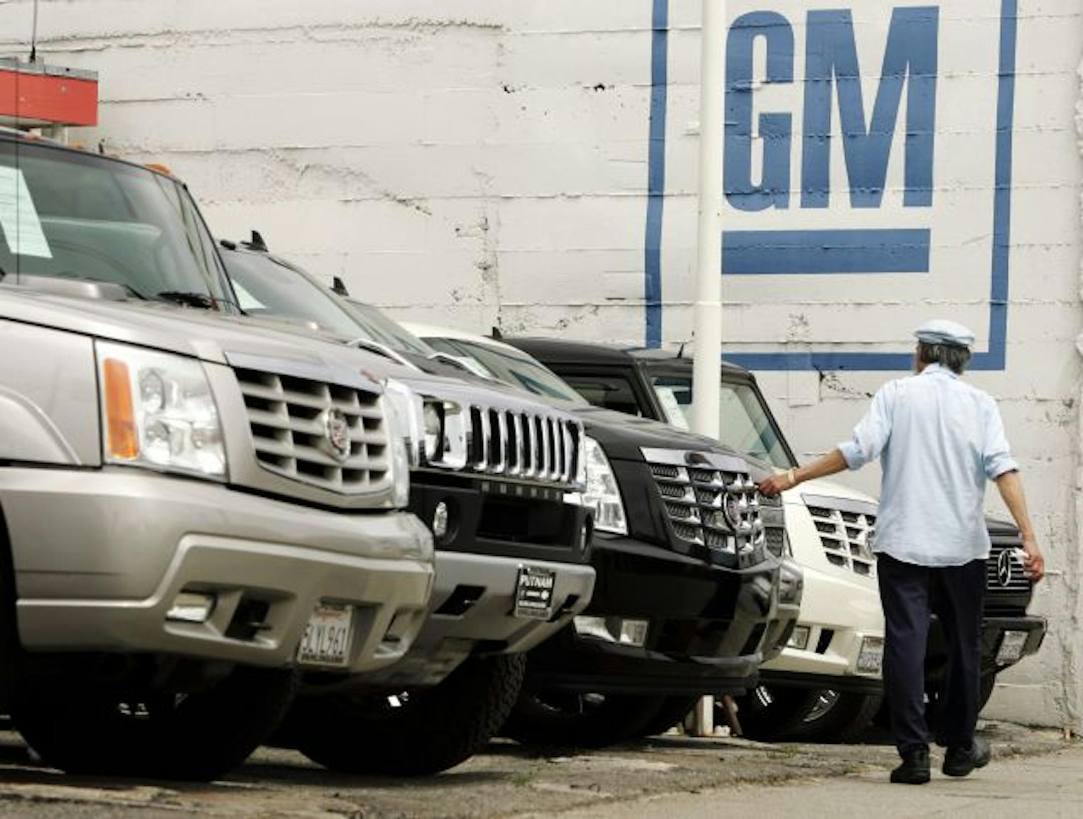 A customer looks at vehicles at a General Motors dealership.