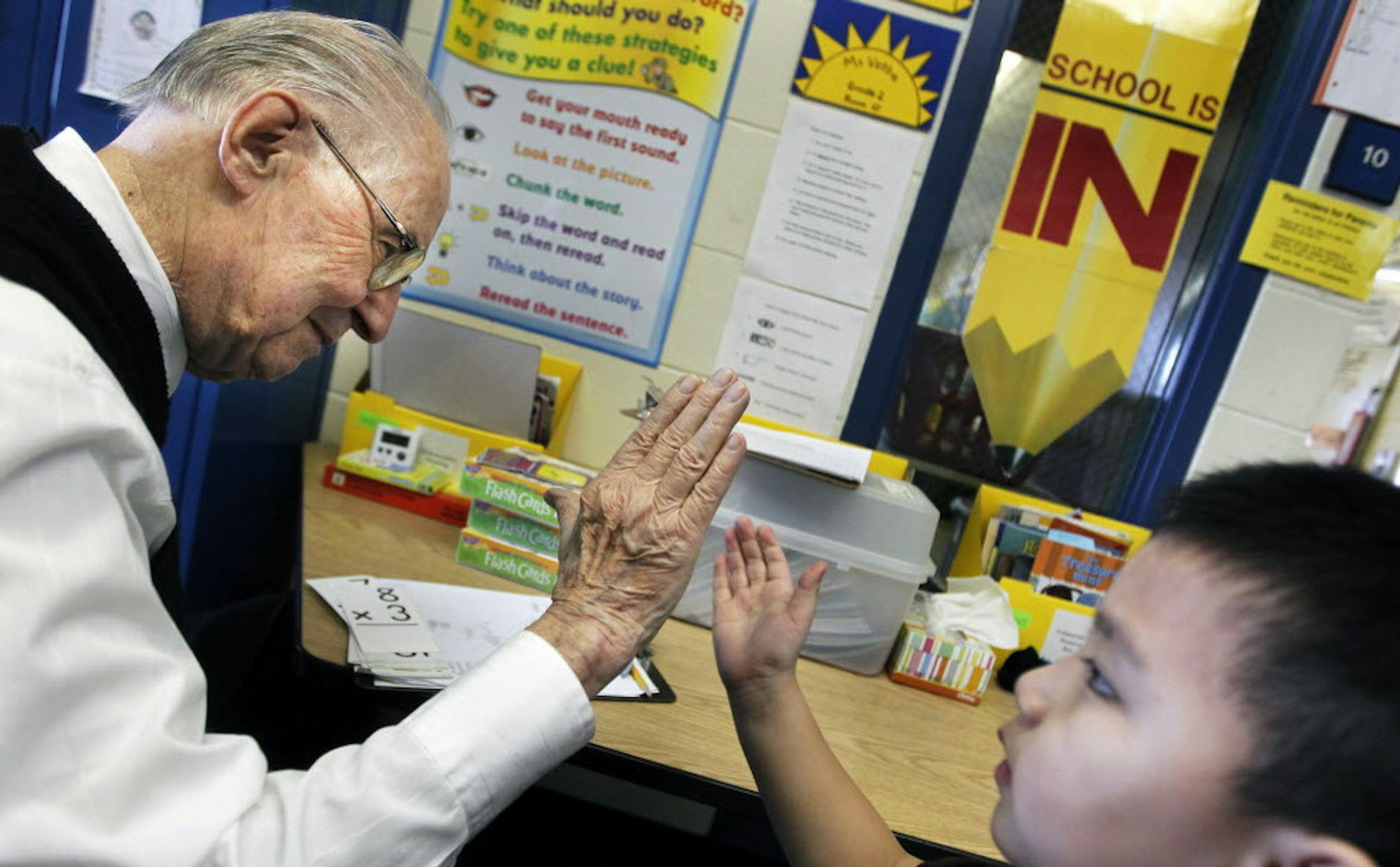 File photo from March 23, 2011 of Andy Anderson, a retired salesman and avid school volunteer, helping Lawthoua Xiong with math at Sunset Hill Elementary in Plymouth. He's been on a crusade to make people more appreciative of teachers, and suggested the city of Plymouth start a "Thank A Teacher Day," which will now take place May 28.
