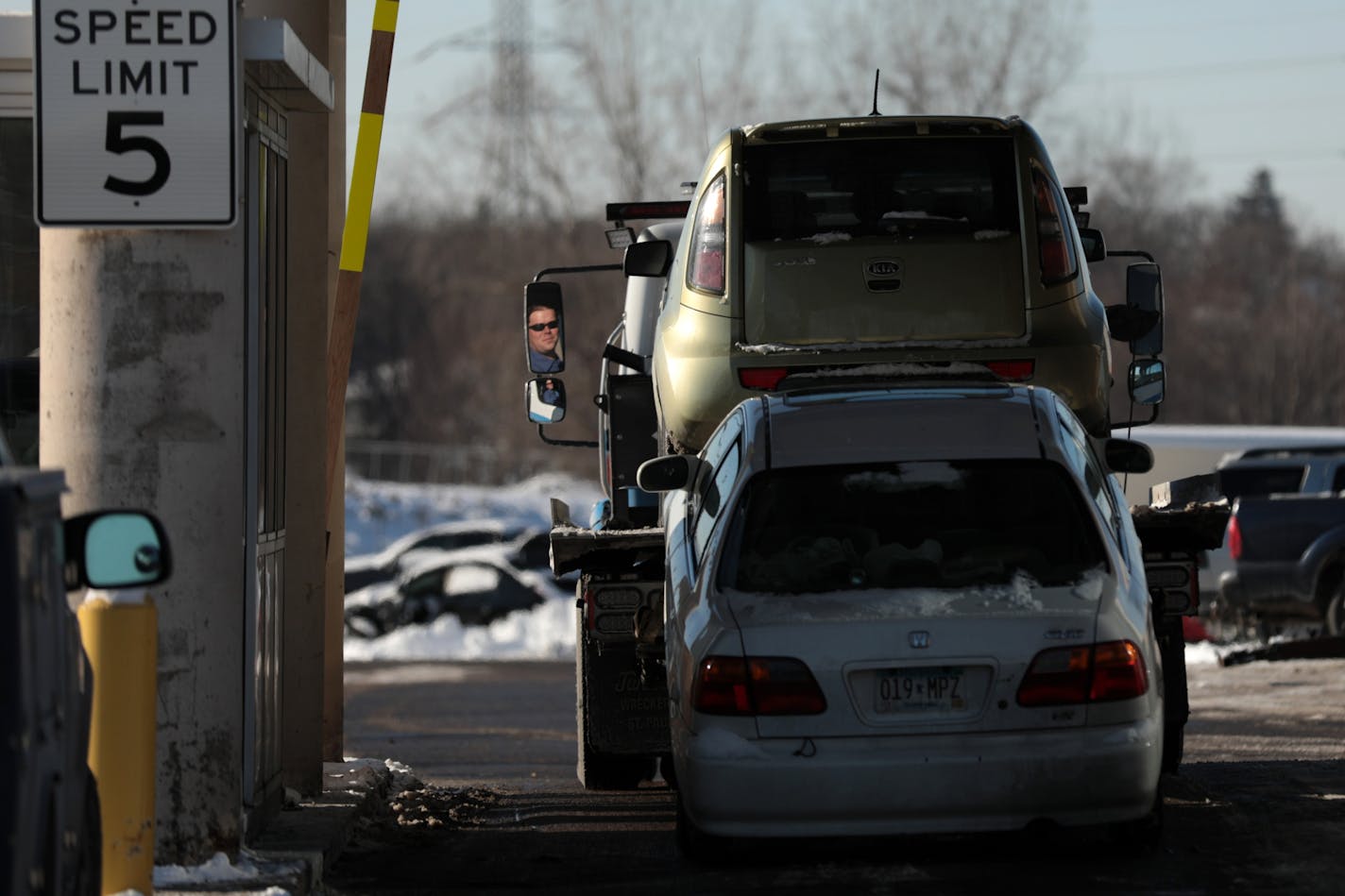 Tow truck drivers bring cars to the city impound lot Tuesday.