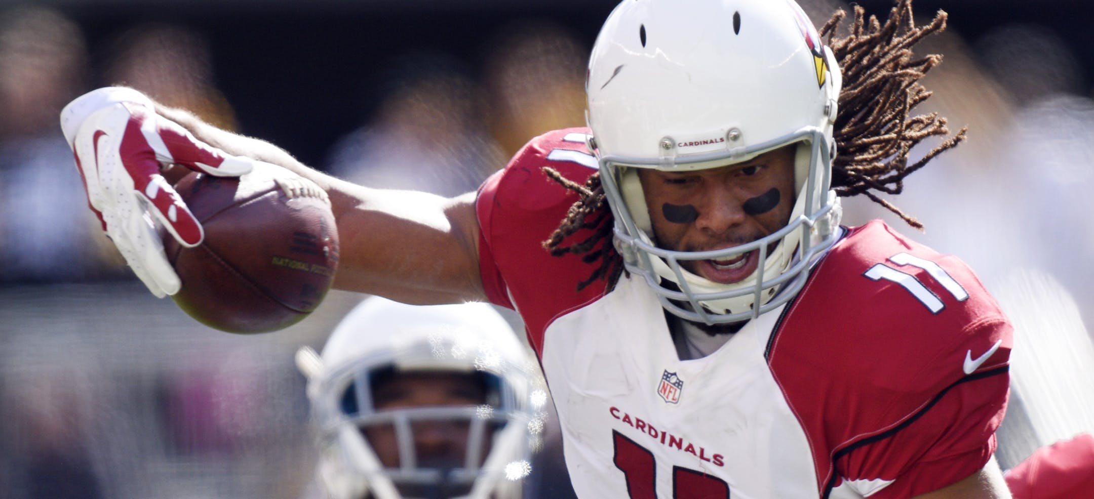 Arizona Cardinals wide receiver Larry Fitzgerald (11) leaps over Pittsburgh Steelers cornerback Antwon Blake (41) after making a catch in an NFL football game, Sunday, Oct. 18, 2015 in Pittsburgh. (AP Photo/Don Wright)