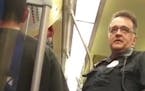 In this photo taken from video, a Metro Transit police officer asked a Blue Line light-rail passenger for his immigration status, leading another pass