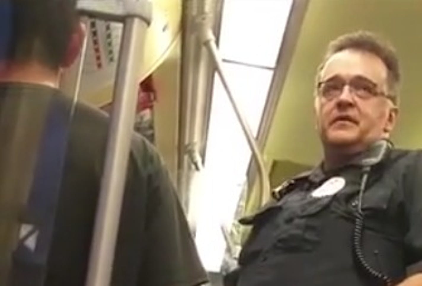 In this photo taken from video, a Metro Transit police officer asked a Blue Line light-rail passenger for his immigration status, leading another passenger to intervene in an exchange caught on video.